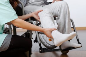 a person receiving physical therapy for their leg