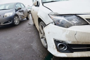 cracked front headlight on a white car