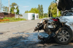 rolled-over truck in the foreground with a smashed-up car