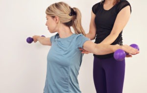 woman receiving physical therapy for her shoulders