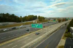Aerial view of freeway intersection with fast moving cars and trucks