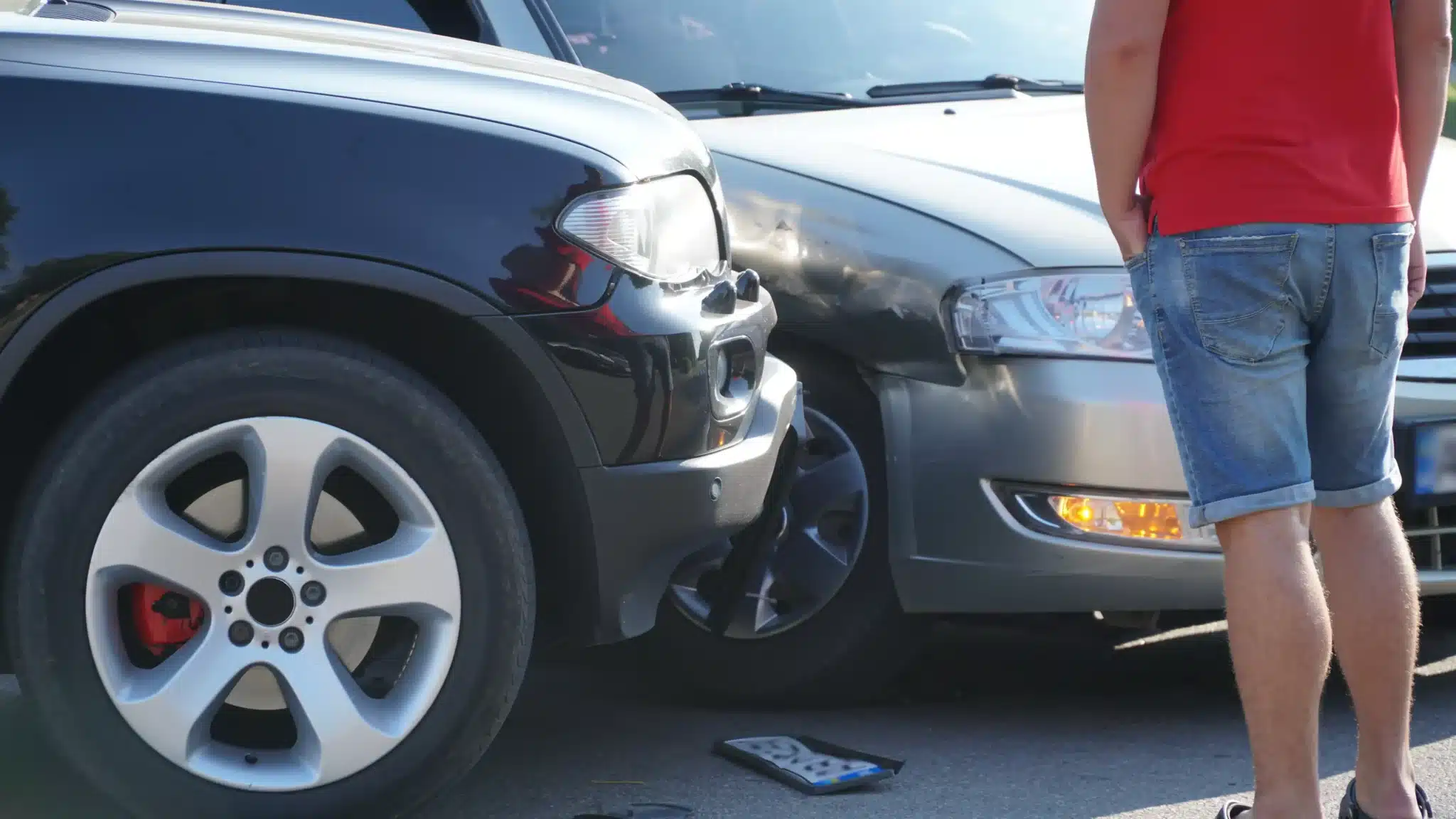 Two cars collide against each other on the road causing an accident