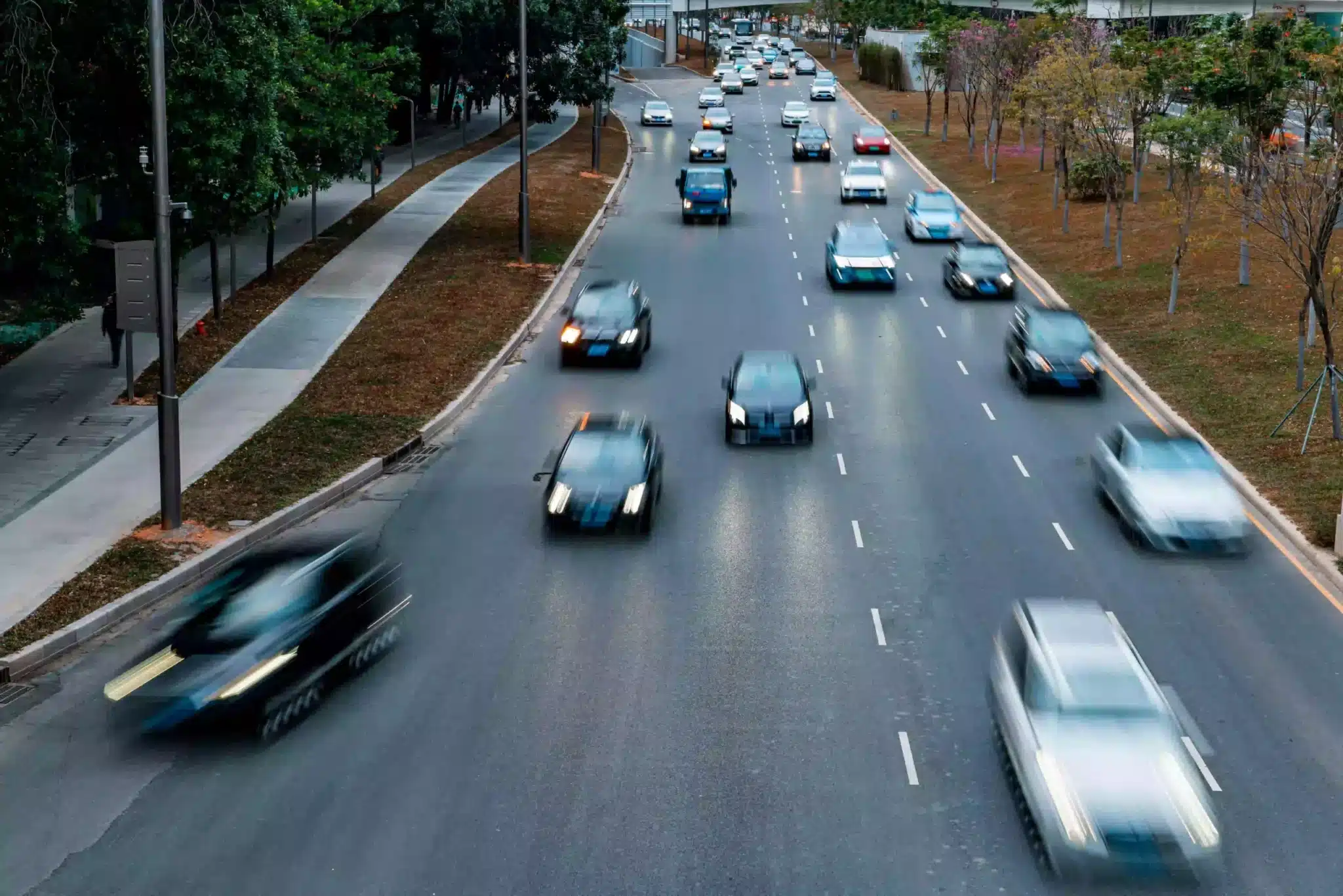 Aerial view of urban traffic in a city with cars speeding