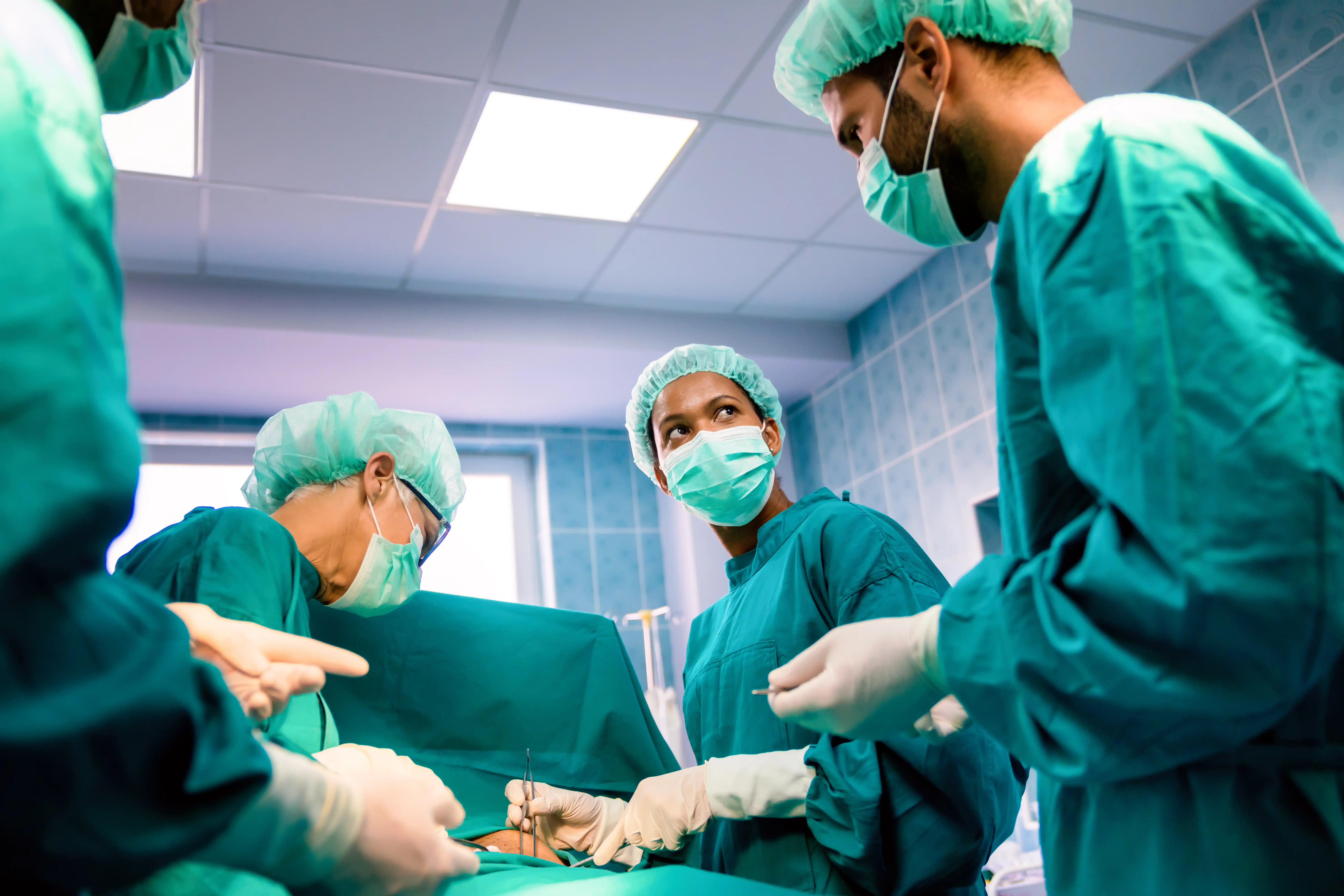 Team of surgeons operating in a surgical room