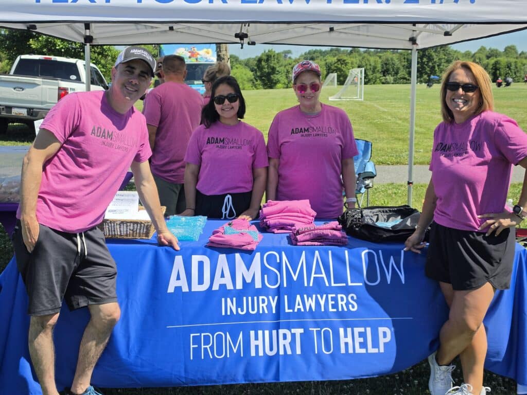 Adam Smallow and the team's group picture at their stall